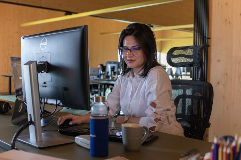 Call center agent smiling while handling an outbound sales call with a headset