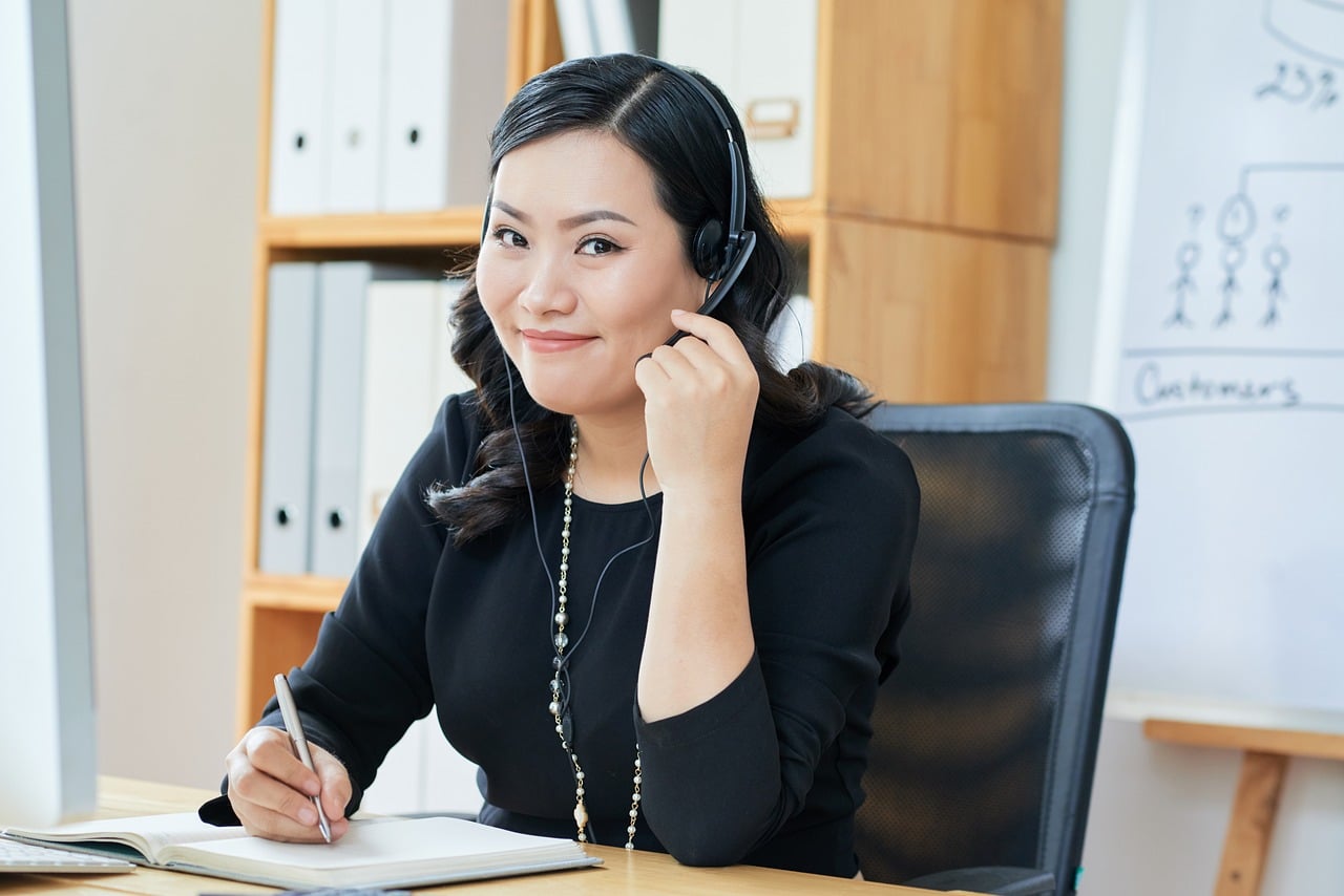 Sales manager coaching a call center agent by reviewing a recorded call together