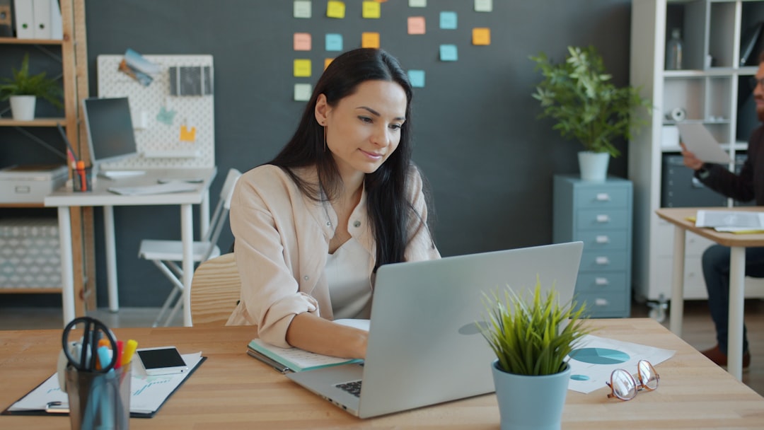 Business owner reviewing stalled revenue data on a computer despite consistent lead generation activity.