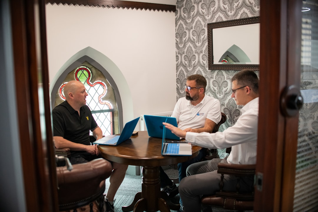 Small business consultant reviewing cost per lead and cost per acquisition data with a client at a conference table.