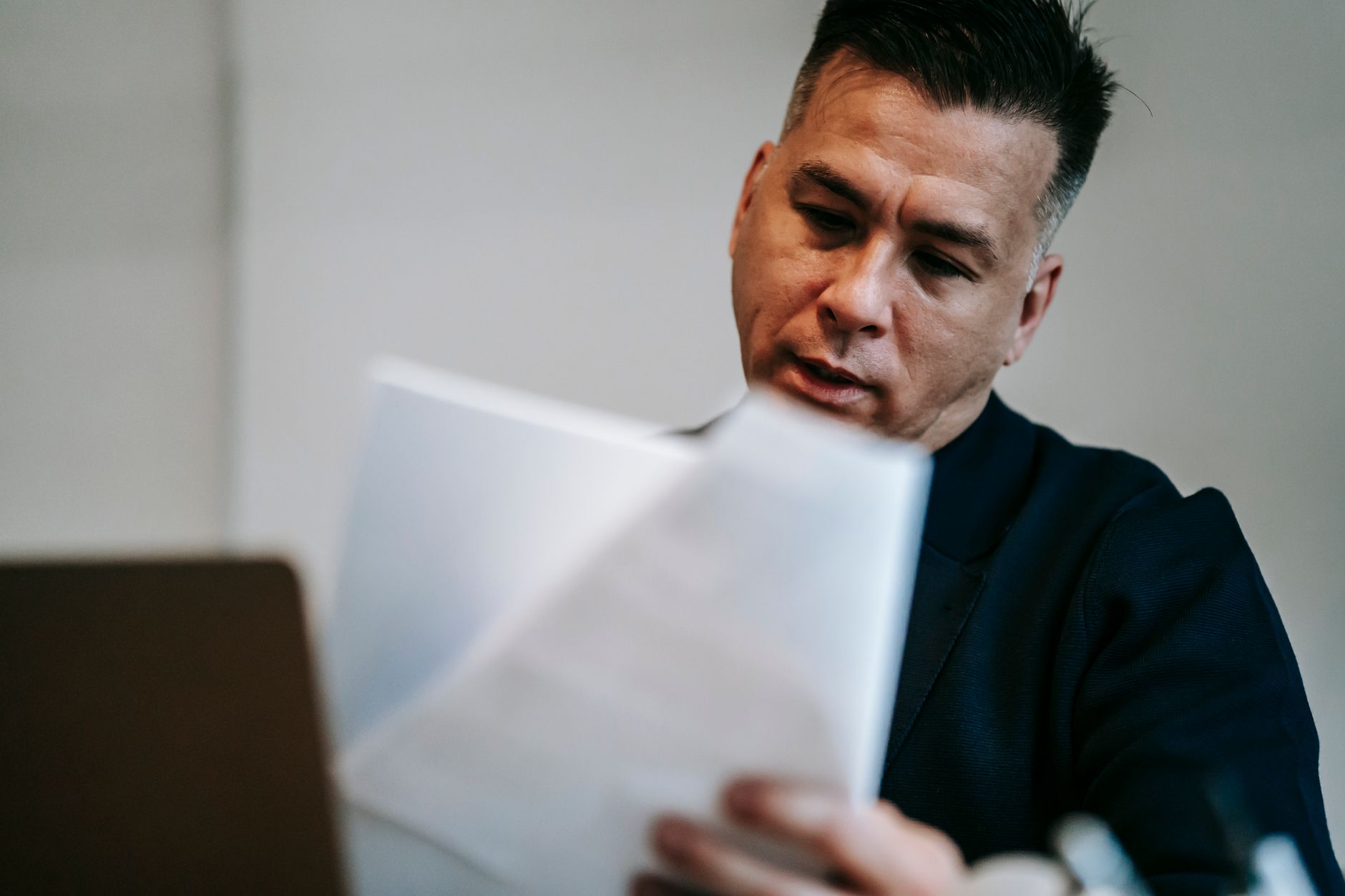 Business owner at a desk reviewing compliance documents related to outbound telemarketing and call center operations.