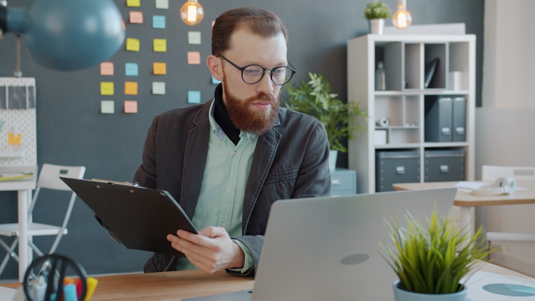 Business owner reviewing poor lead generation results on a laptop screen at an office desk.