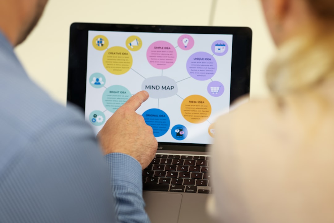 A marketing team reviewing lead generation analytics on a laptop dashboard in an office setting.