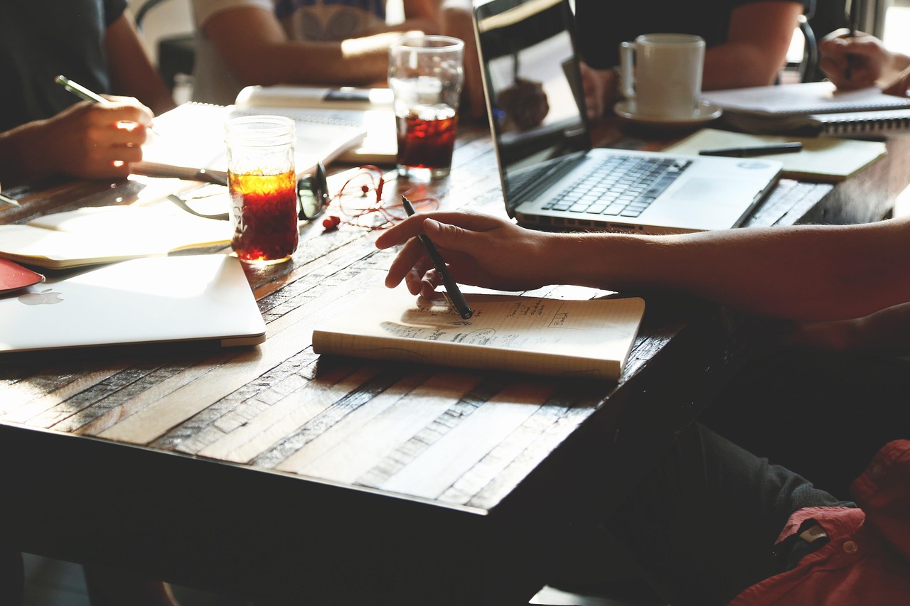 Two business professionals reviewing lead generation vendor proposal documents at a conference room table.