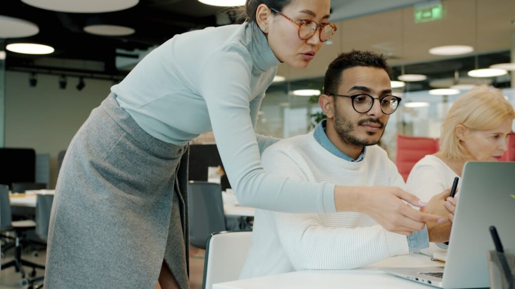 Call center manager reviewing team performance reports at a desk.