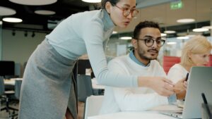 Call center manager reviewing team performance reports at a desk.