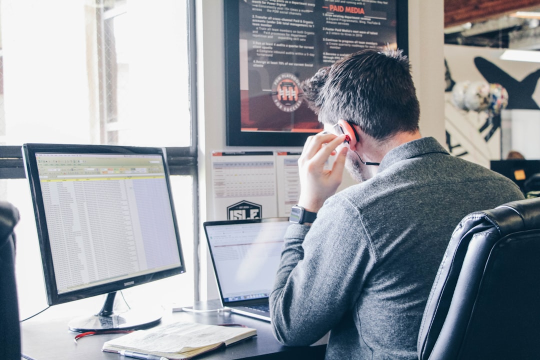 Addiction treatment admissions coordinator reviewing patient inquiry strategy at a computer.
