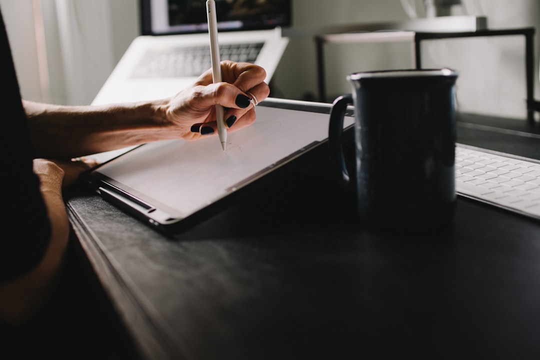 Business owner reviewing legal compliance contracts and documents at an office desk.